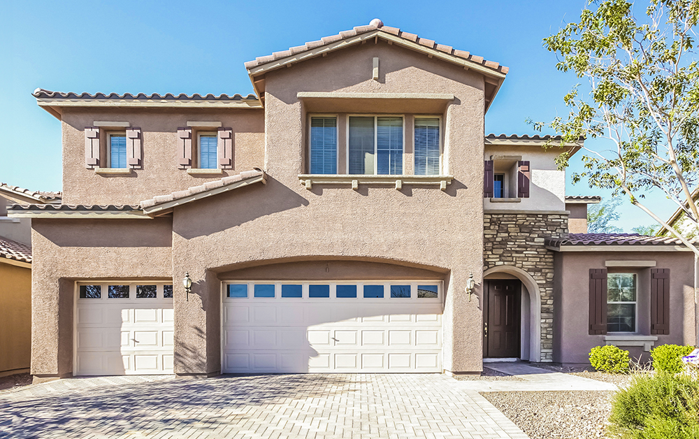 Progress Residential rental home with beige exterior, driveway, and garage.
